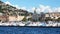 COMO, ITALY - SEPTEMBER 12, 2017: A scenic Italian village at bank of big mountain lake with ships moored, Como, Italy