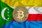Comores flag, bitcoin gold coin on flag background. The concept of blockchain, bitcoin, currency decentralization in the country.
