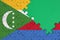 Comoros flag is depicted on a completed jigsaw puzzle with free green copy space on the right side