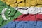 Comoros flag depicted in paint colors on old stone wall closeup. Textured banner on rock wall background