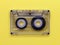 Compact audio tape cassette on yellow background