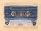 Compact Cassette Audio Tape on Wooden Background