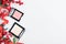 Compact powder and blush on a light festive background with holly Christmas decor top view. Gifts for a woman in a winter holiday