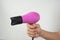 Compact purple hairdryer in hand isolate