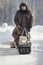 Compact snowmobile for hunting - motorcycle towing pulls cargo on snow countryside