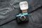 Compact vintage plastic film camera on dark grey jeans