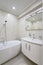 Compact white cozy bathroom with bathub