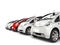 Compact white electric cars in a row - red stands out