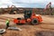 Compaction roller rolls sand on construction site