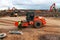 Compaction roller rolls sand on construction site