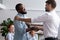 Company boss congratulating handshaking with successful employee