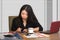 Company corporate portrait of young beautiful and busy Asian Korean woman working busy at modern office computer desk by venetian