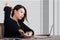 Company corporate portrait of young beautiful and busy Asian Korean woman working busy at modern office computer desk by venetian