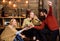 Company of friends celebrate with mulled wine in cozy atmosphere, wooden background. Cheers concept. Friends talking and