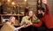 Company of friends celebrate with mulled wine in cozy atmosphere, wooden background. Cheers concept. Man and ladies on