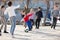 Company of glad children playing football on the street