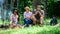 Company hikers relaxing at picnic forest background. Spend great time on weekend. Halt for snack during hiking. Company