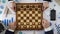 Company leaders playing chess, using business strategy to win market, top view