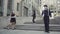 Company of three mimes have fun standing near office center background