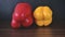 Compare the bottom of red and yellow peppers.