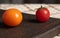 Comparison concept with different tomatoes. Tomato cherry with sepal and pedicel.Tomato fruits on wooden board