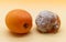 Comparison between a healthy apricot and a rotten apricot