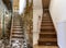 Comparison of modern brown wooden staircase in new renovated apartment interior and old ladder stairs. Before renovation and after