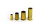 Comparison of sizes of different used bullet shells on a white isolated background with reflection from a tin table top. View of