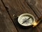 Compass on brown wooden background