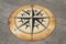 The compass is drawn on a concrete slab