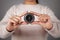 Compass in the hand of a young woman. Gray background