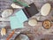 Compass, magnifier, notepad, pencil, sea stones on a textural wooden table