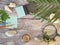 Compass, magnifier, notepad, pencil, sea stones on a textural wooden table