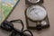 Compass, map and flint on a stone surface. Magnesium fire starter. Tourist equipment. Navigation equipment and campfire equipment