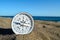 Compass on the Sand Beach