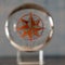 Compass symbol through glass ball