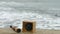 Compass and telescope spyglass on sand. Sunken barge, bollard and bitt