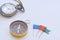 Compass, vintage hanging necklace watch and flag pin on white background, direction concept