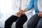 Compassion can heal a lot. a doctor holding hands with a patient in her consulting room.