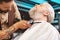 Competent barber using hair clipper