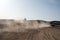 Competition racing challenge desert. Car overcome sand dunes obstacles. Car drives offroad with clouds of dust. Offroad