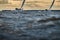 Competition of two sailboats on the horizon in sea at sunset, the amazing storm sky of different colors, race, big waves