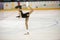 Competitions in figure skating among children.The girl figure skater performs a complex