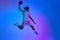 Competitive, ambitious sportsman, young basketball player in motion with ball against gradient blue background in neon
