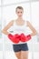 Competitive woman with red boxing gloves posing