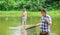 Competitors. male friendship. family bonding. summer weekend. two fishermen with fishing rods, selective focus. mature