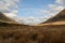 Complete rainbow over tussock grasses, New Zealand