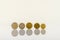 Complete set of euro coins standing on a white table with reflections