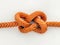 Complex Orange Rope Knot on White Background