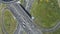 Complex Road Junction and Cars Traffic in Sunny Summer Day. Drone is Orbiting Around. Aerial View. Vertical Video